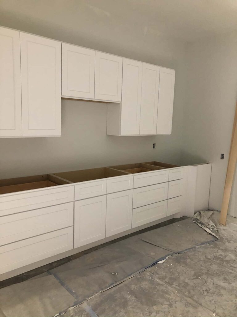 Modern Unfinished White Shaker Cabinet Kitchen with no countertop